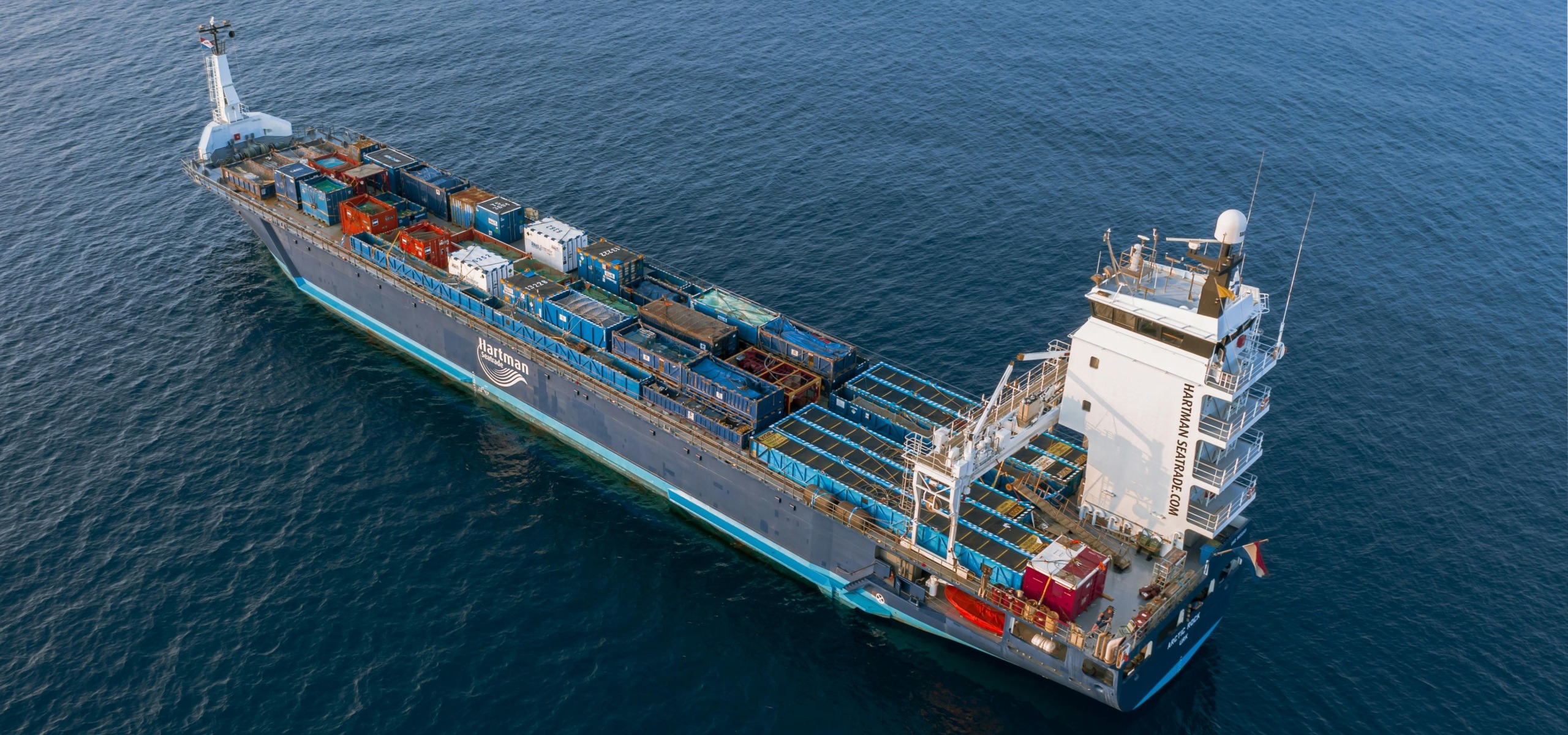 Large cargo container ship at sea, ready for sustainable marine shore power connection