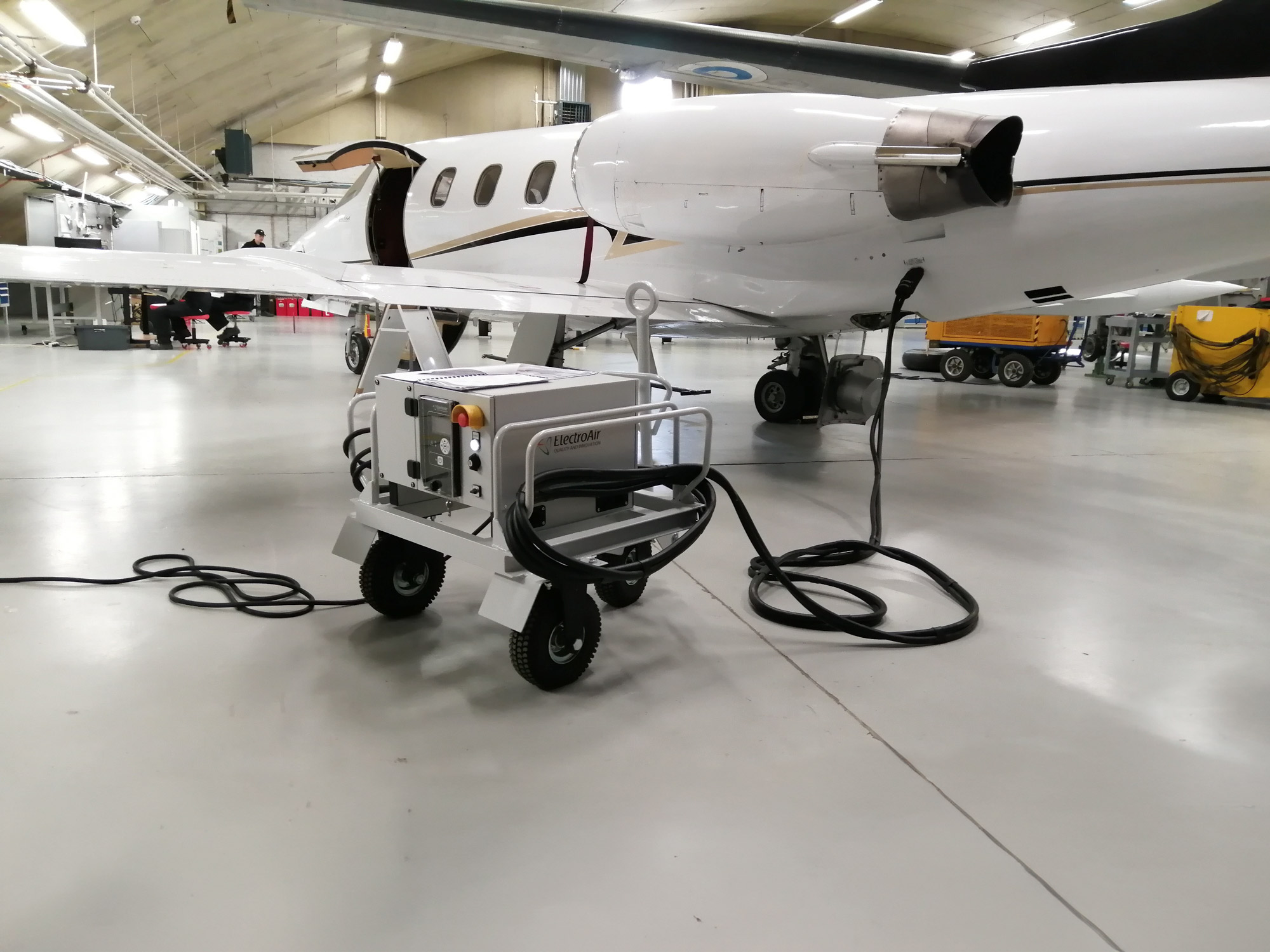 ElectroAir GPU connected to a private jet on the apron, delivering 28V DC power.