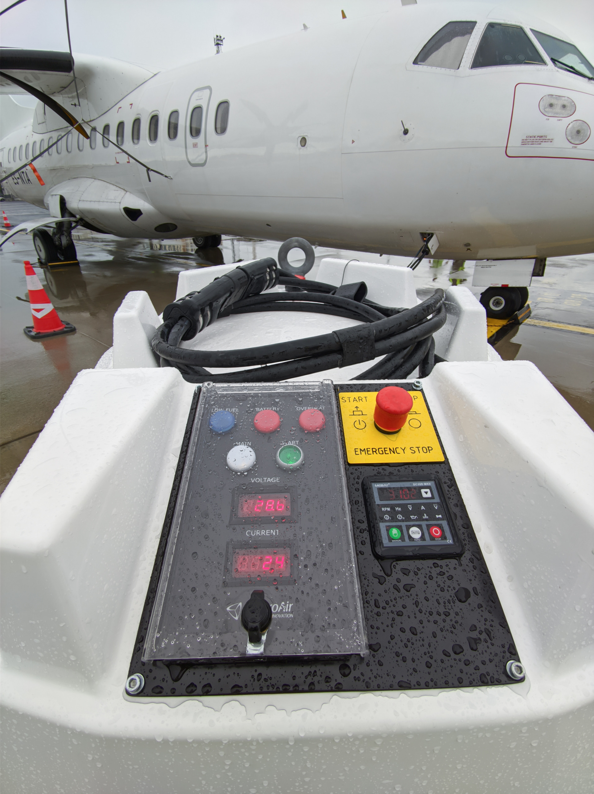 ElectroAir Ground Power Unit connected to regional aircraft on wet runway - operating within safe load limits