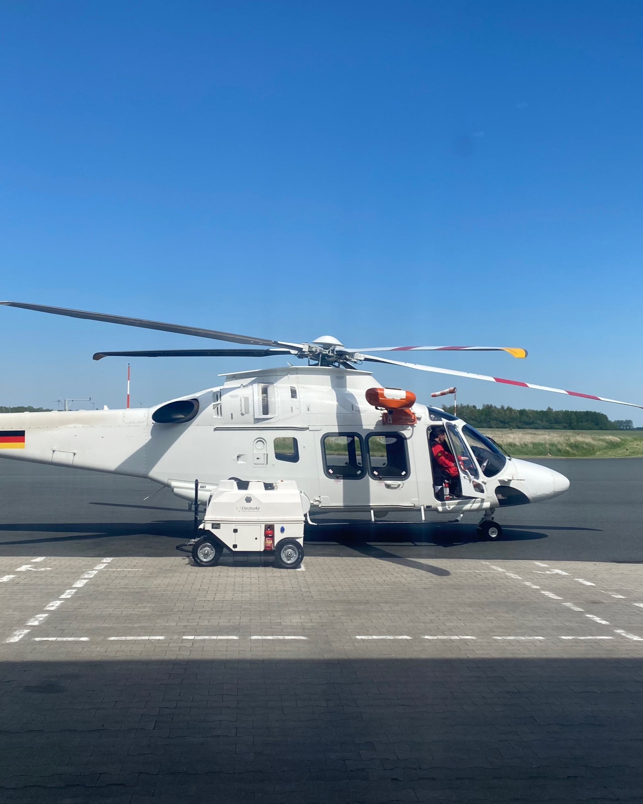 ElectroAir mobile Ground Power Unit (GPU) connected to a helicopter for pre-flight ground power supply