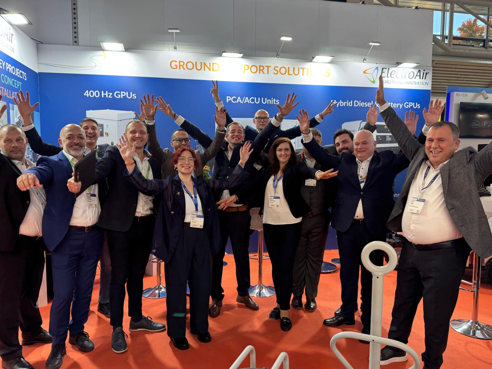 ElectroAir team celebrating together at the Inter Airport Europe 2025 exhibition stand, showcasing ground support and 400 Hz GPU solutions.