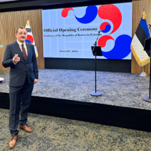 ElectroAir representative standing in front of the official stage at the Korean Embassy opening ceremony in Estonia.